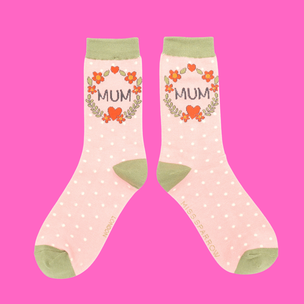 
                      
                        A pair of socks with a floral wreath Mum motif. Pink legs, light green cuff, heel and toe.
                      
                    