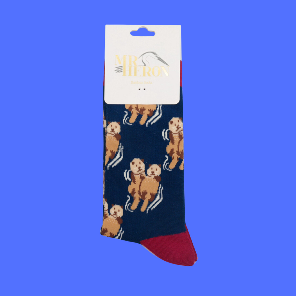 
                  
                    A pair of socks depicting otters holding hands. Blue legs, red heel, toe and cuff.
                  
                