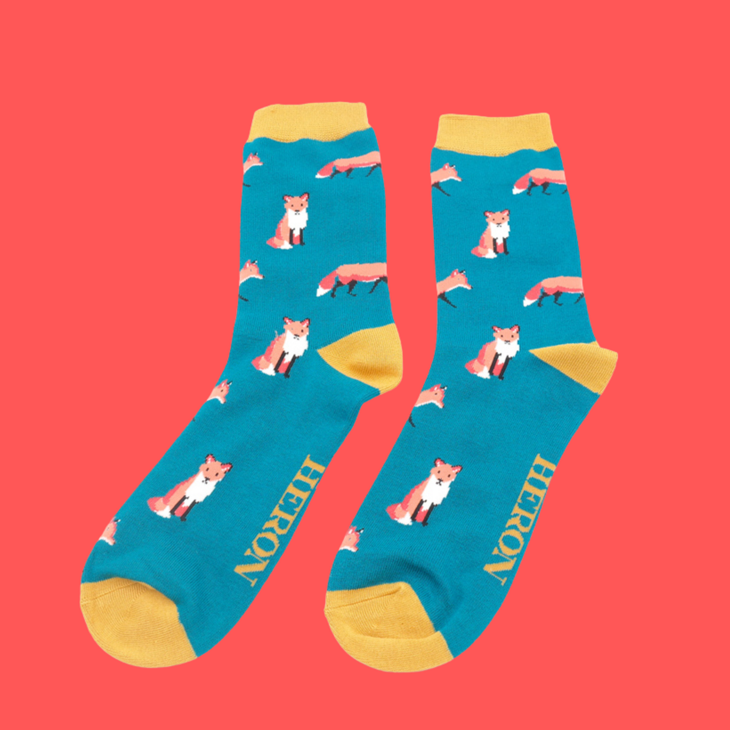 
                  
                    A pair of socks featuring a cute fox design. Blue legs, green cuff, heel and toe.
                  
                