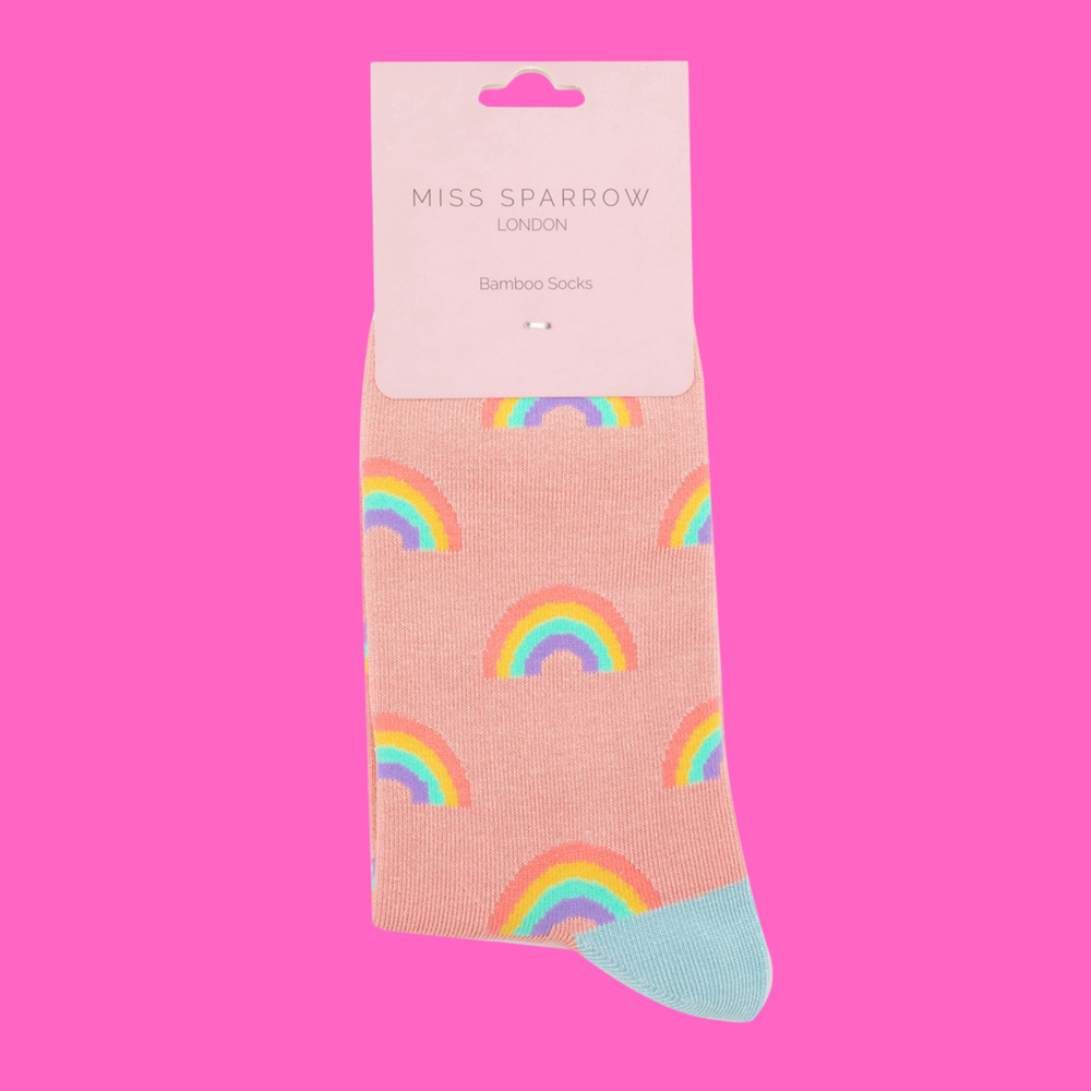 
                  
                    A pair of socks with a rainbow pattern. Peach legs, light blue cuff, toe and heel.
                  
                