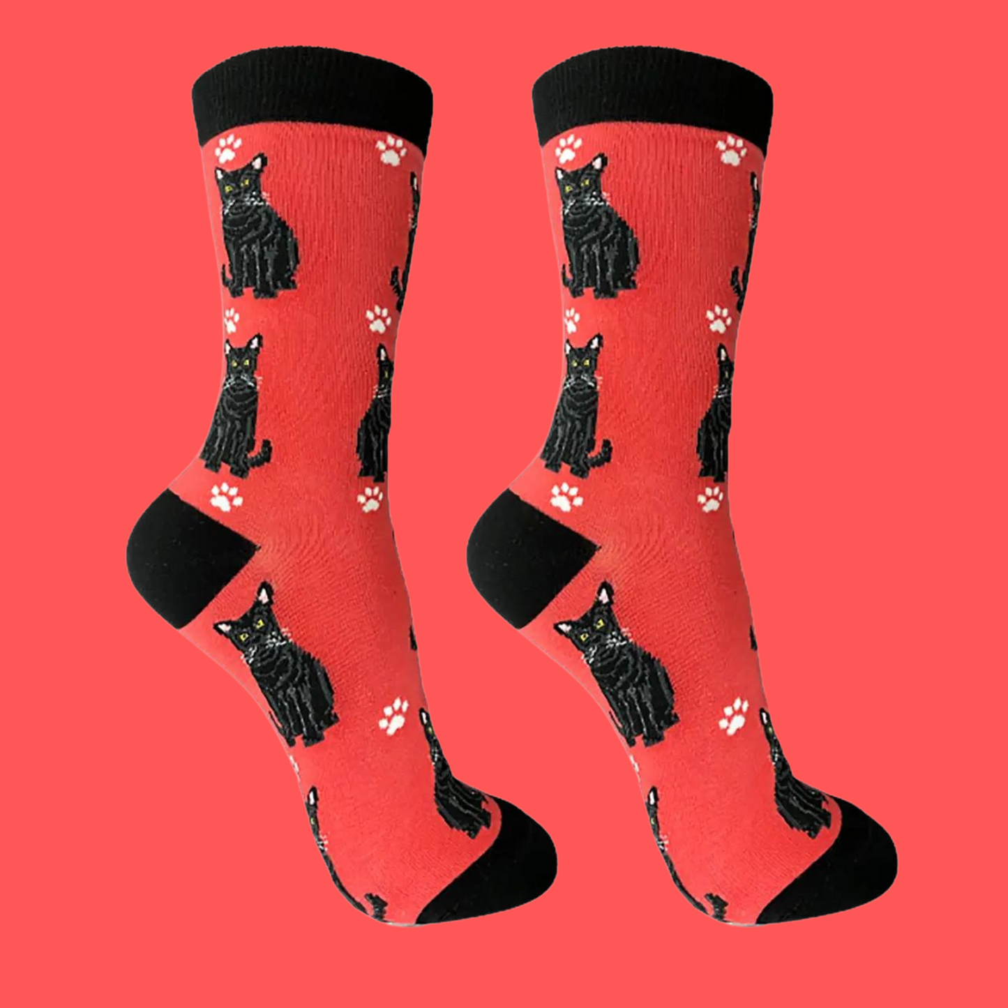 A pair of socks featuring black cats. Red legs, black heel, toe and cuff.