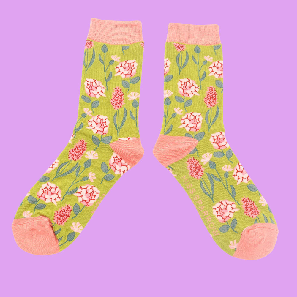 
                  
                    A pair of socks depicting British flowers and plants. Yellow legs, peach heel, cuff and toe.
                  
                