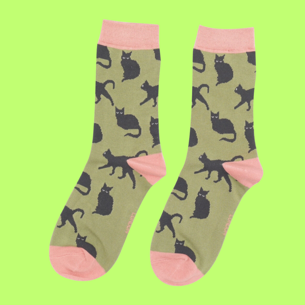 
                  
                    A pair of socks depicting cute black cats. Green legs, pink toe, cuff and heel.
                  
                