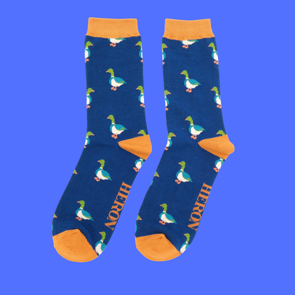 
                  
                    A pair of socks with a pattern of ducks. Dark blue legs, orange cuff, toe and heel.
                  
                