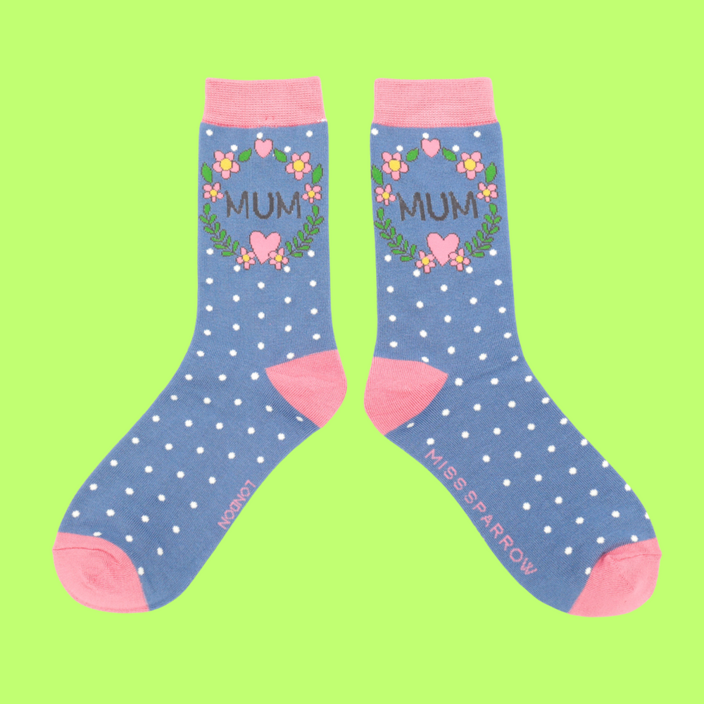 
                      
                        A pair of socks with a floral wreath Mum motif. Blue legs, light pink cuff, heel and toe.
                      
                    