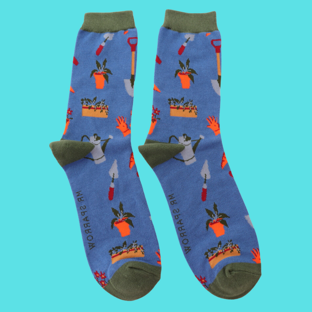 
                      
                        A pair of socks featuring gardeners tools, blue legs, grey heel, toe and cuff. 
                      
                    