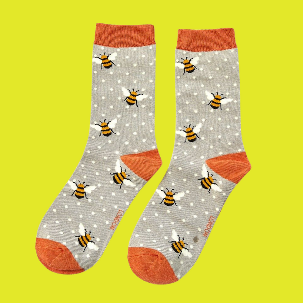 
                      
                        A pair of socks depicting bumble bees. Grey legs, orange cuff, toe and heel.
                      
                    