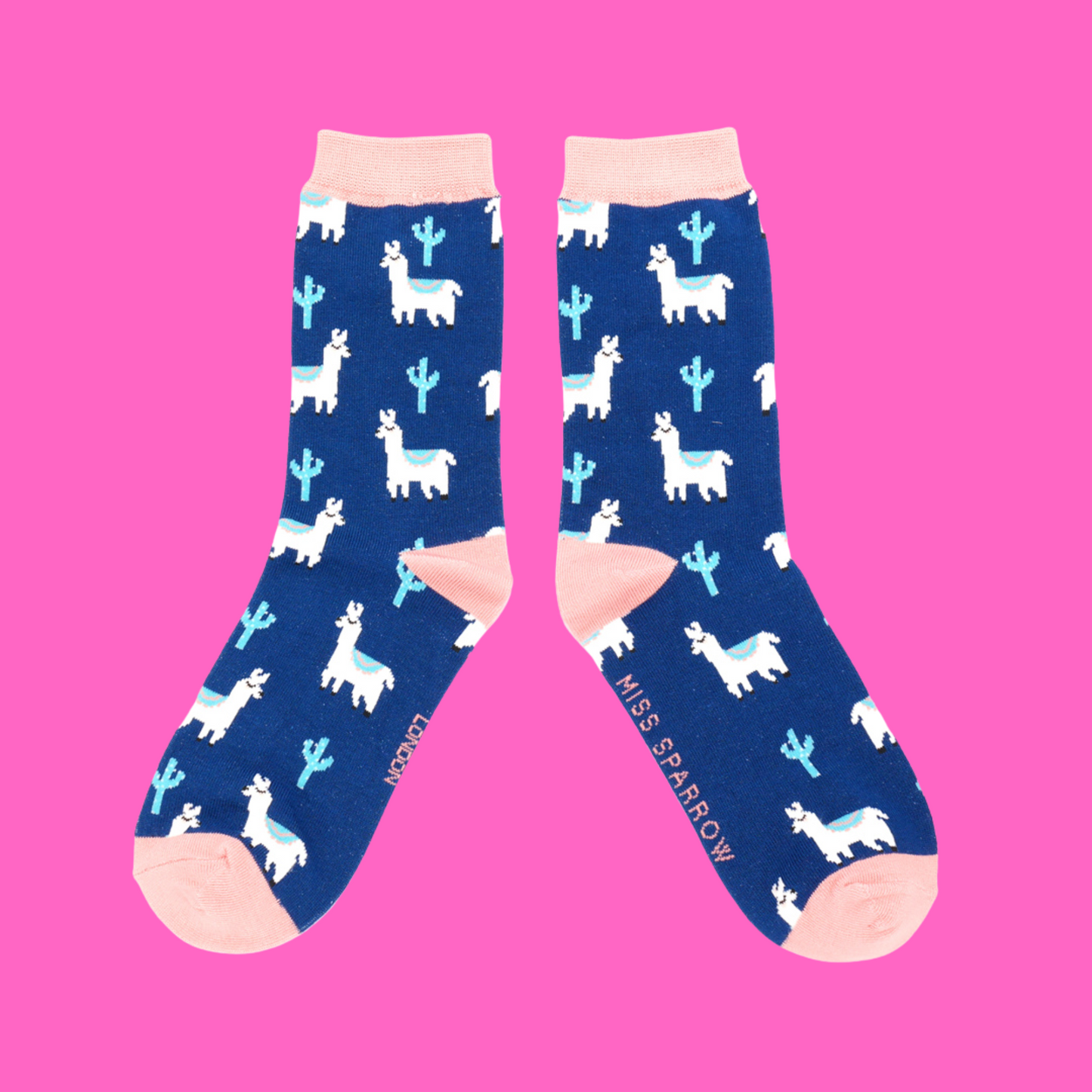 
                  
                    A pair of socks depicting cacti and Llamas. Dark legs, light pink cuff, heel and toe.
                  
                