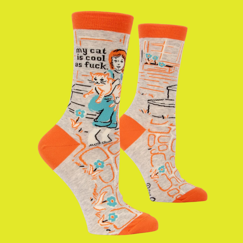 A pair of socks depicting cool cats. Brown legs, orange heel, toe and cuff. 