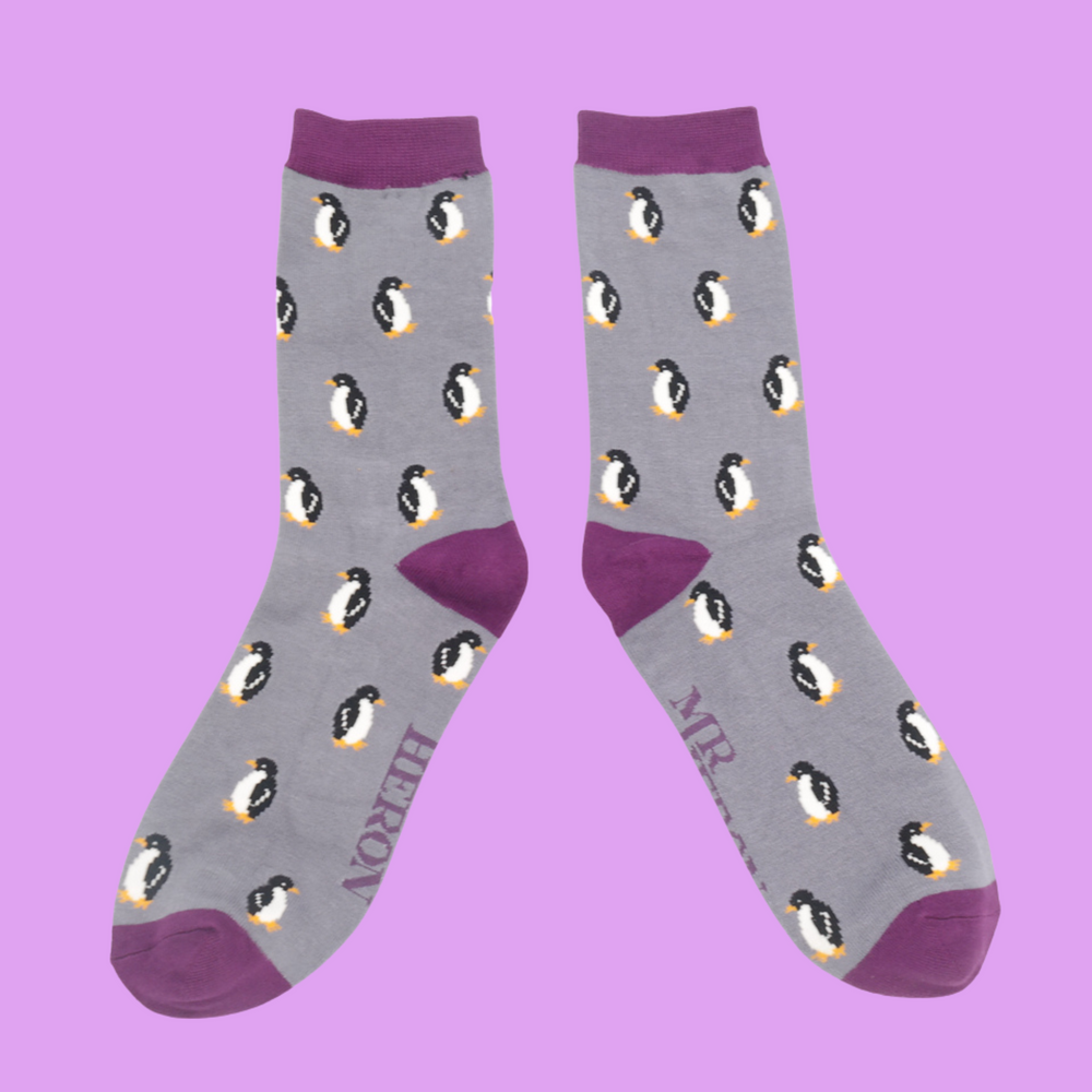 
                  
                    A pair of socks with a penguin pattern. Grey legs, purple heel, cuff and toe.
                  
                