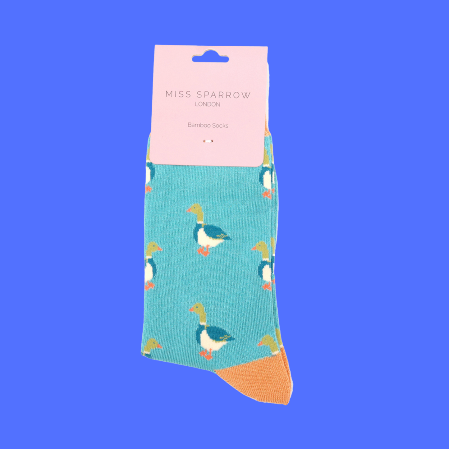 
                  
                    A pair of socks with a pattern of ducks. Teal legs, orange cuff, toe and heel.
                  
                