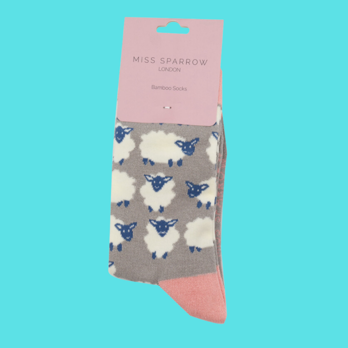 
                  
                    A pair of socks depicting happy sheep. Grey legs, pink heel, toe and cuff.
                  
                