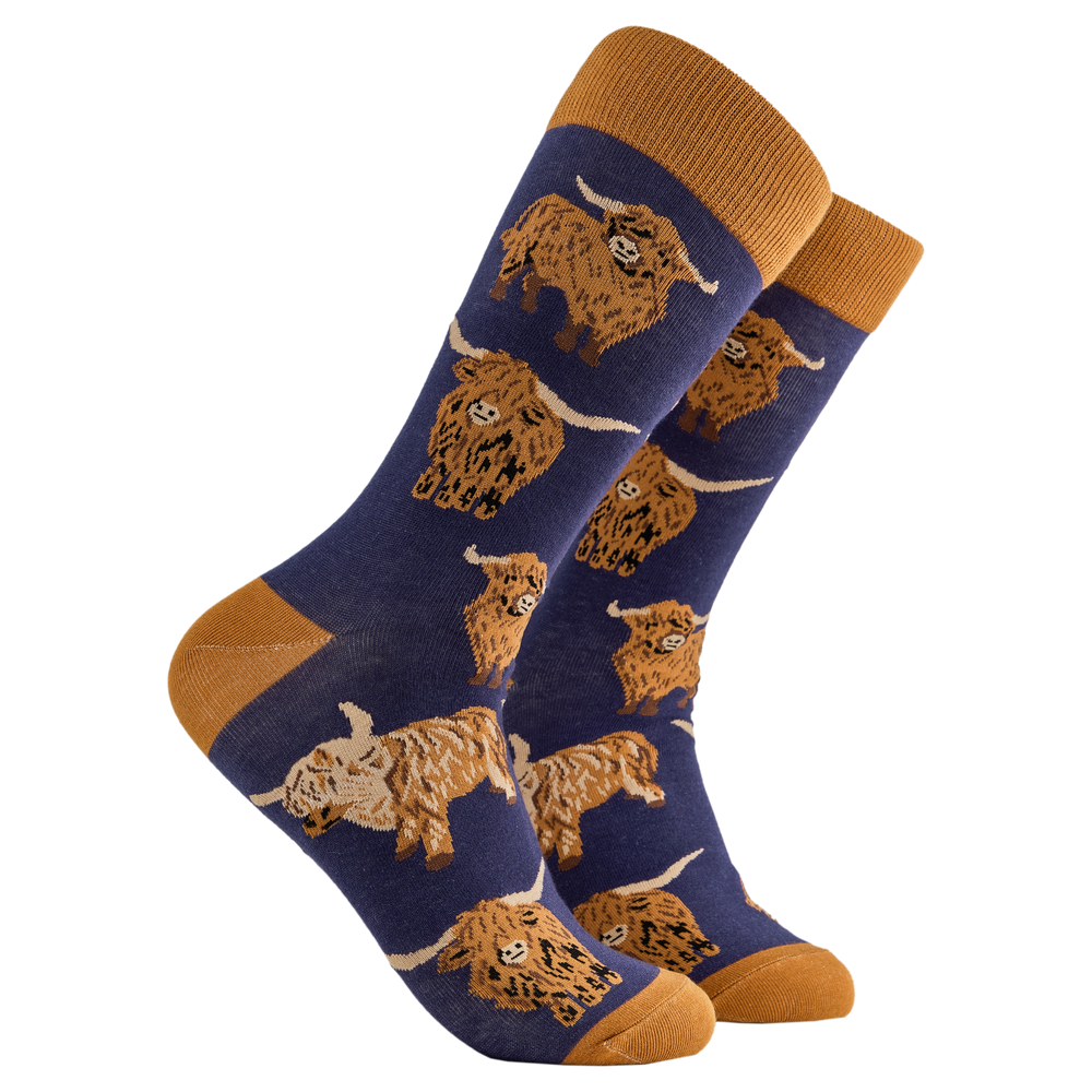 Highland Cow Socks - Och Aye the Moo! A pair of socks depicting highland cows. Blue legs, brown cuff, heel and toe.