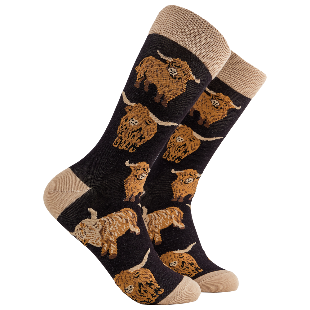 
                      
                        A pair of socks depicting highland cows. Black legs, cream cuff, heel and toe.
                      
                    