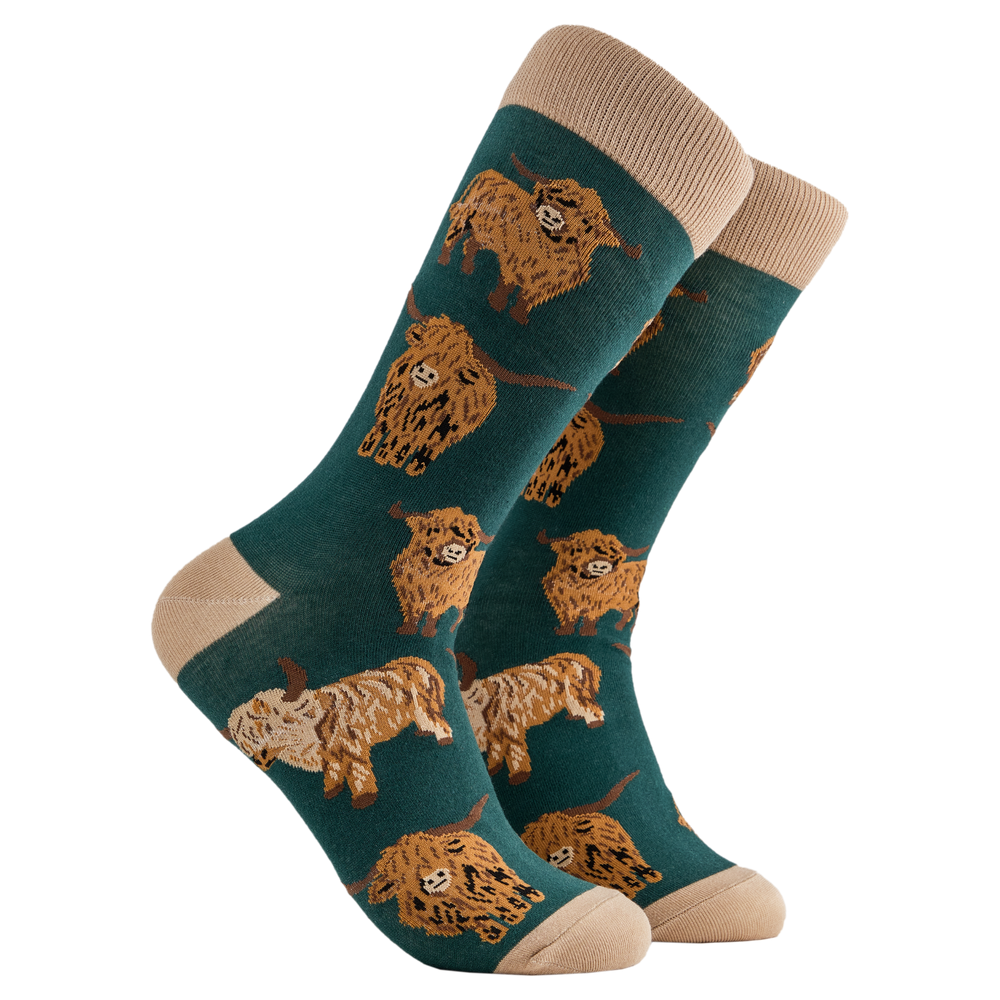 
                  
                    A pair of socks depicting highland cows. Dark green legs, cream cuff, heel and toe.
                  
                