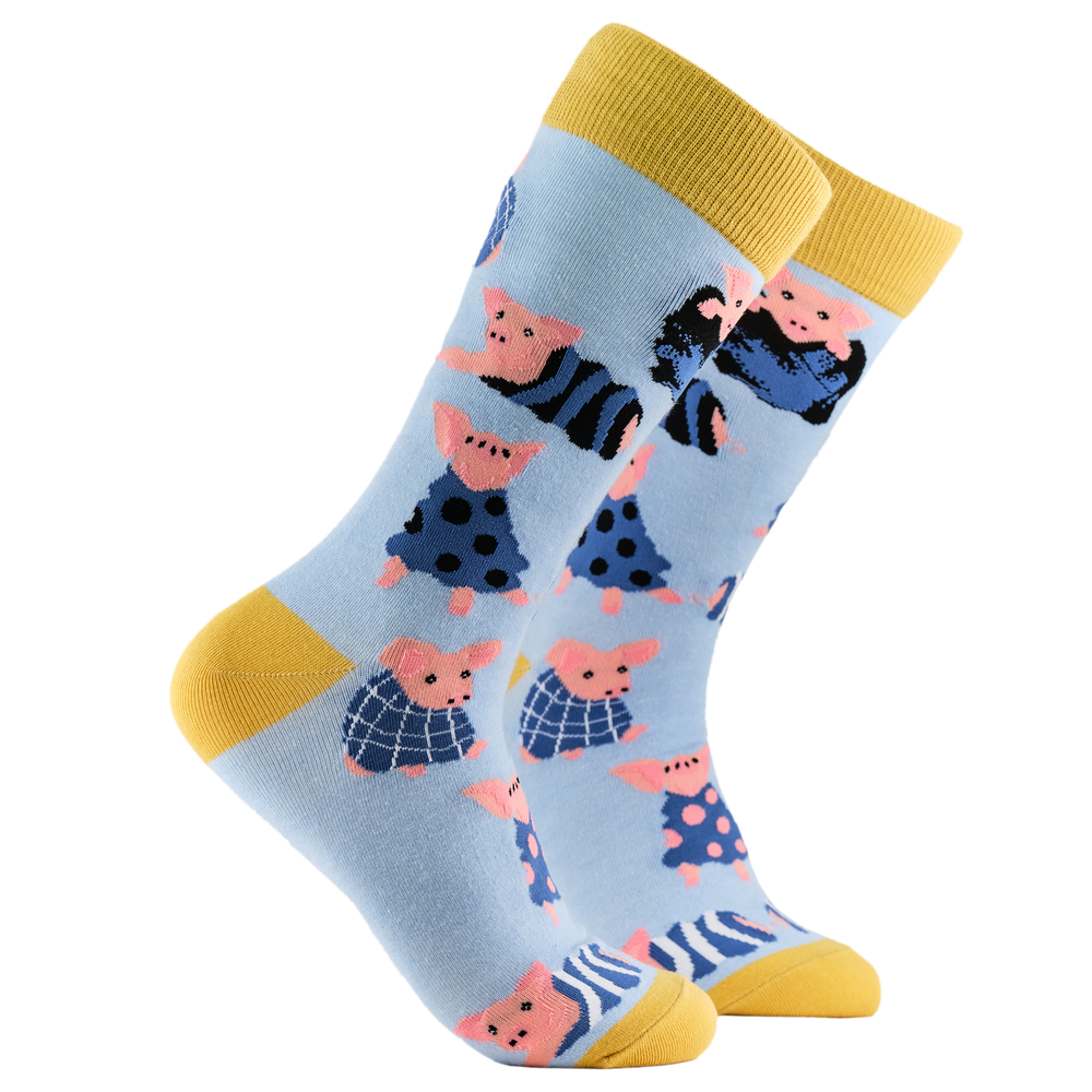 Pig Socks - Pigs in Blankets. A pair of socks depicting Pigs wrapped up in cosy blankets. Blue legs, yellow cuff, heel and toe.