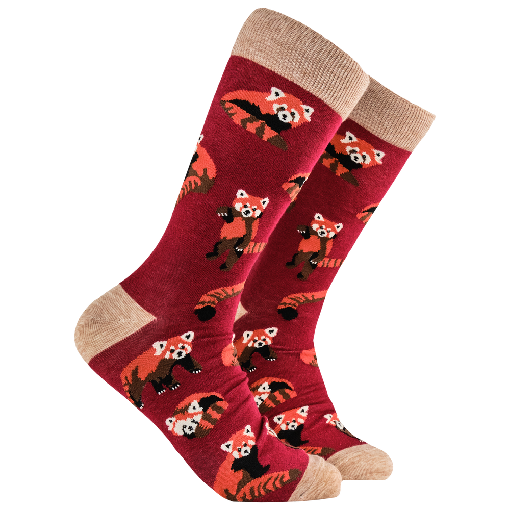 A pair of socks depicting cute little red pandas. Red legs, brown heel, toe and cuff. 