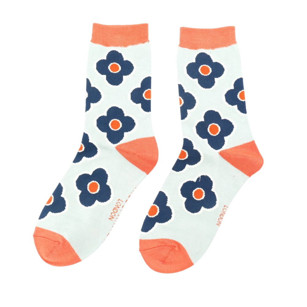 
                      
                        A pair of socks depicting a retro flower pattern. Cream legs, orange heel, toe and cuff.
                      
                    