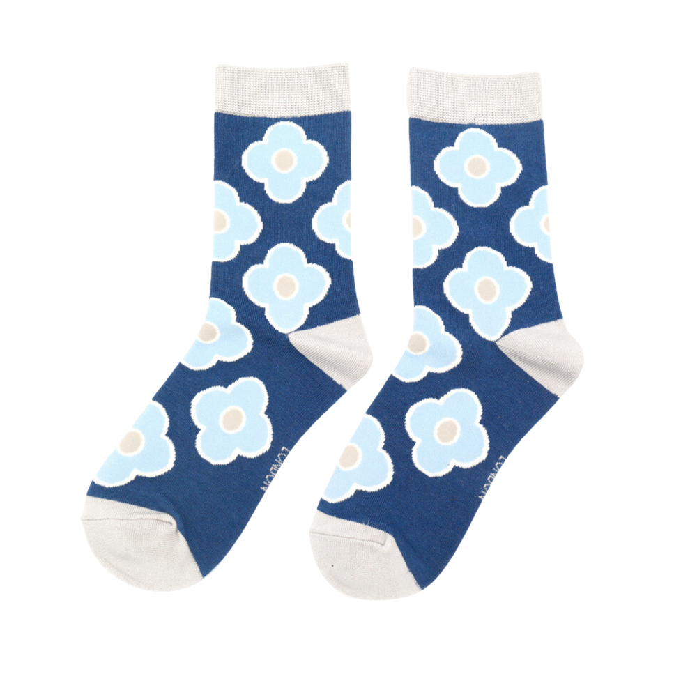 A pair of socks depicting a retro flower pattern. Blue legs, cream heel, toe and cuff.