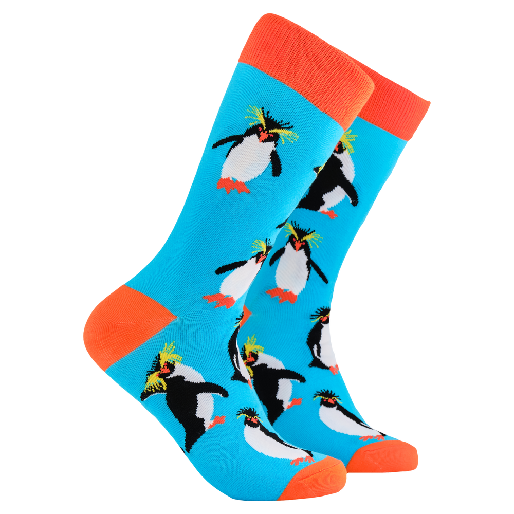 Penguin Socks - Rock Hopper. A pair of socks depicting rock hopper penguins. Bright legs, orange cuff, heel and toe.