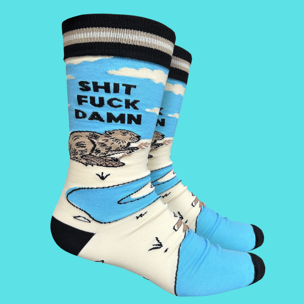 
                  
                    A apir of socks with a blod blue otter motif and a sweary slogan. Blue legs, black toes, cuff and heel.
                  
                