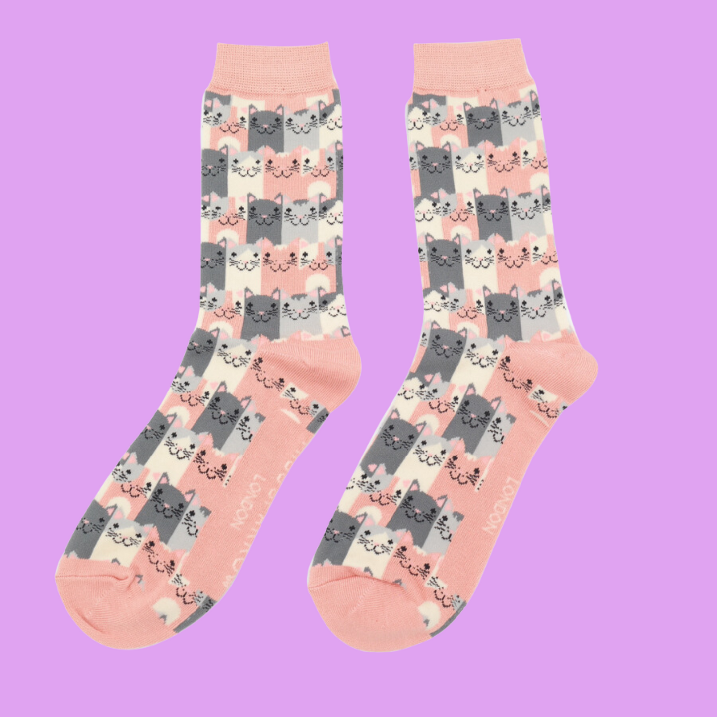 
                  
                    A pair of socks with a multicoloured happy anime cat pattern. Peach heel, toe and cuff.
                  
                