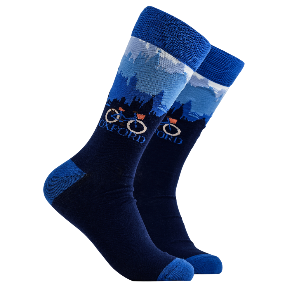 Oxford Socks - SOXFORD. A pair of socks depicting the Oxford skyline and a traditional bicycle. Blue legs, blue cuff, heel and toe.