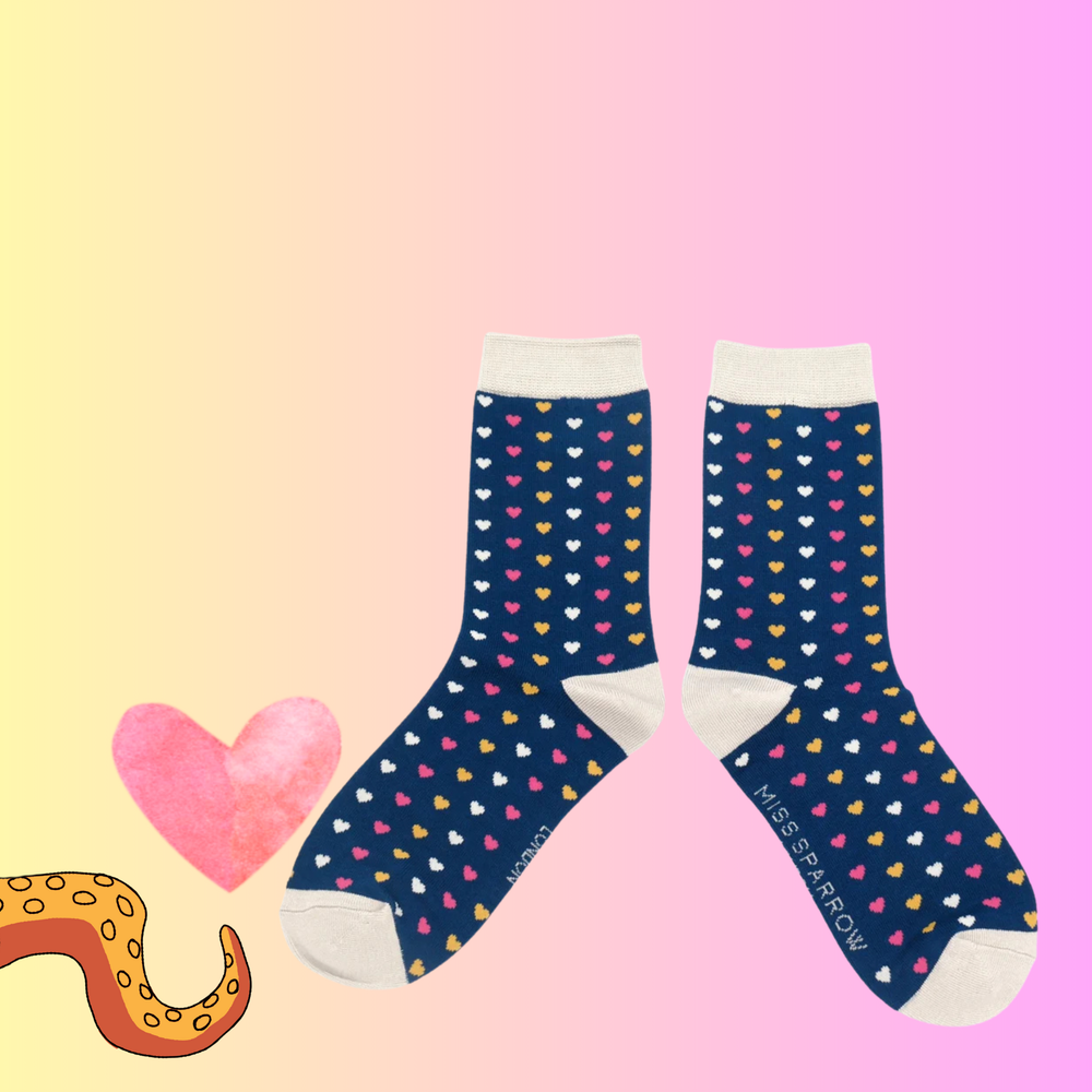 A pair of bamboo socks with a heart pattern blue legs, yellow toe, heel and cuff. 