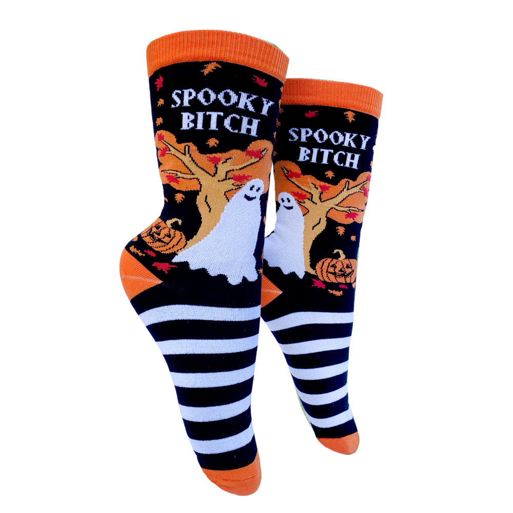 Spooky B**ch Socks - Small. A pair of socks depicting a selection of halloween items. Black and white legs, orange toe, cuff and heel. 