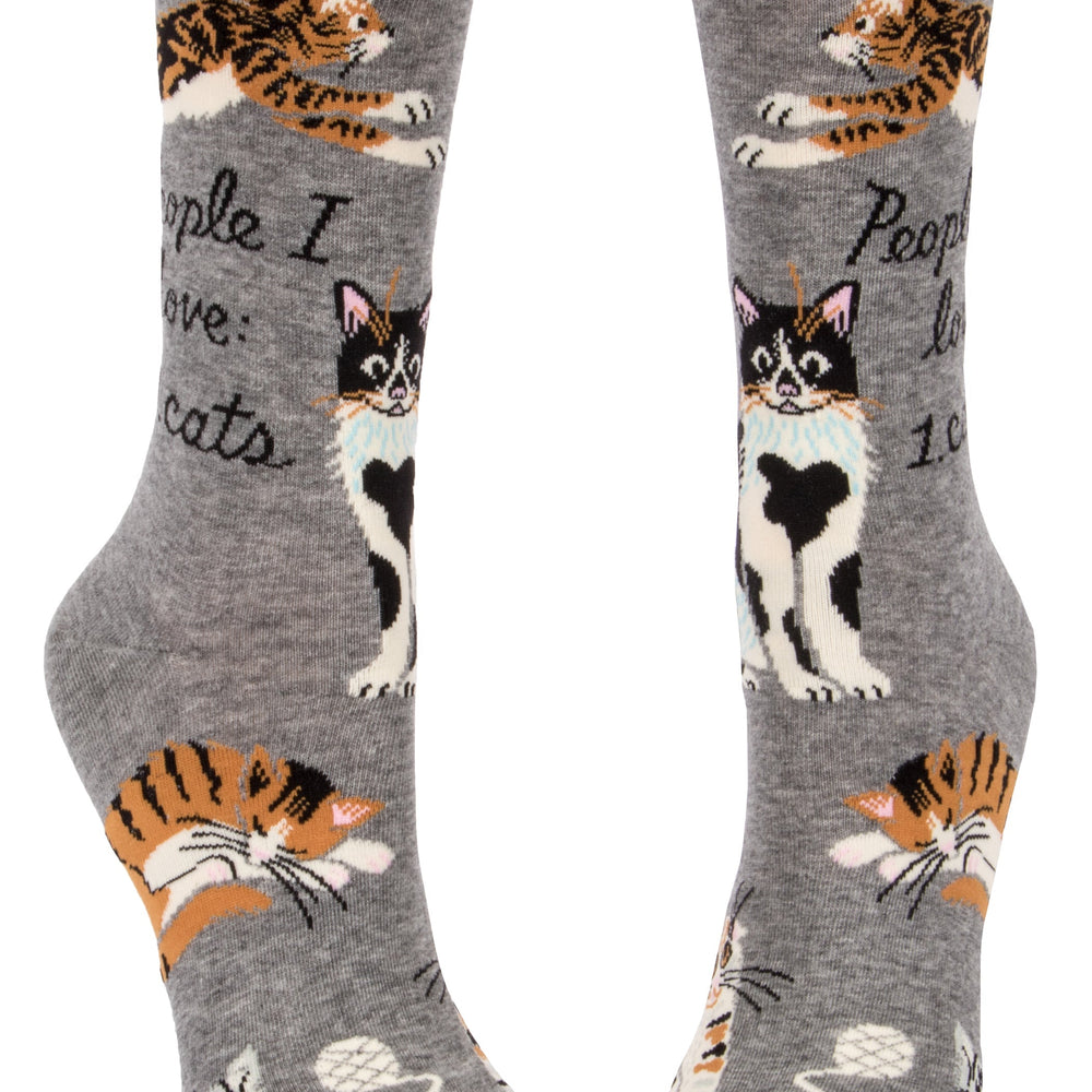 
                      
                        A pair of socks featuring playful cats. Grey legs, heel, toe and cuff. 
                      
                    