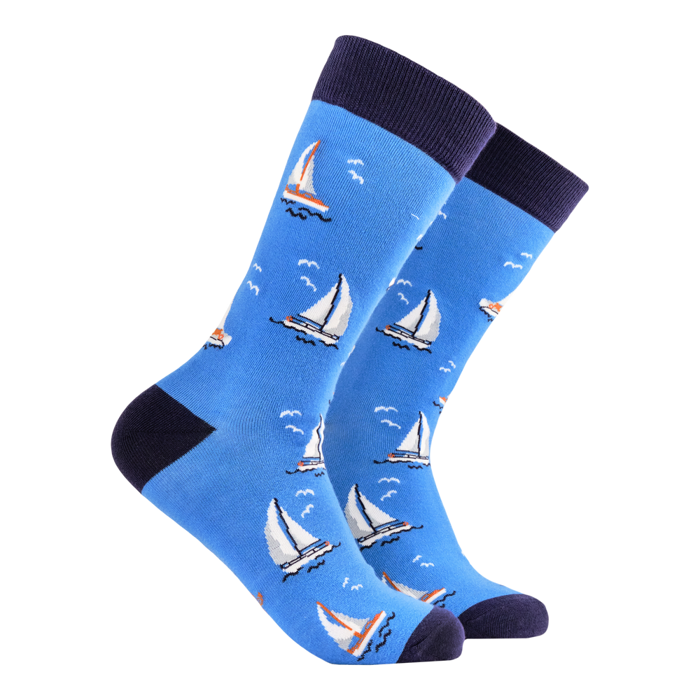 Sailing Bamboo Socks. A pair of socks featuring sail boats. Bright blue legs, dark blue heel, toe and cuff. 