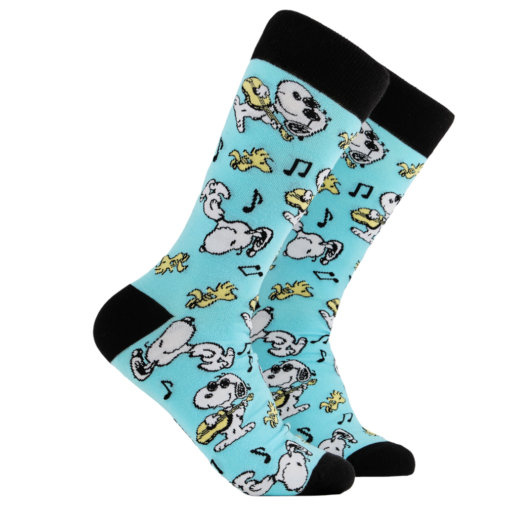 Peanuts Socks - Snoopy Jammin'. A pair of socks depicting snoopy and woodstock jamming. Turquoise legs, black cuff, heel and toe. 