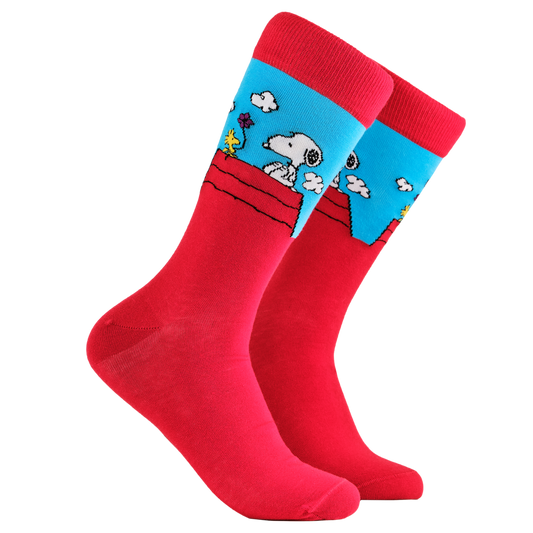 Peanuts Socks - Snoopy & Woodstock. A pair of socks depicting snoopy and woodstock on the dog house. Red legs, red cuff, heel and toe.