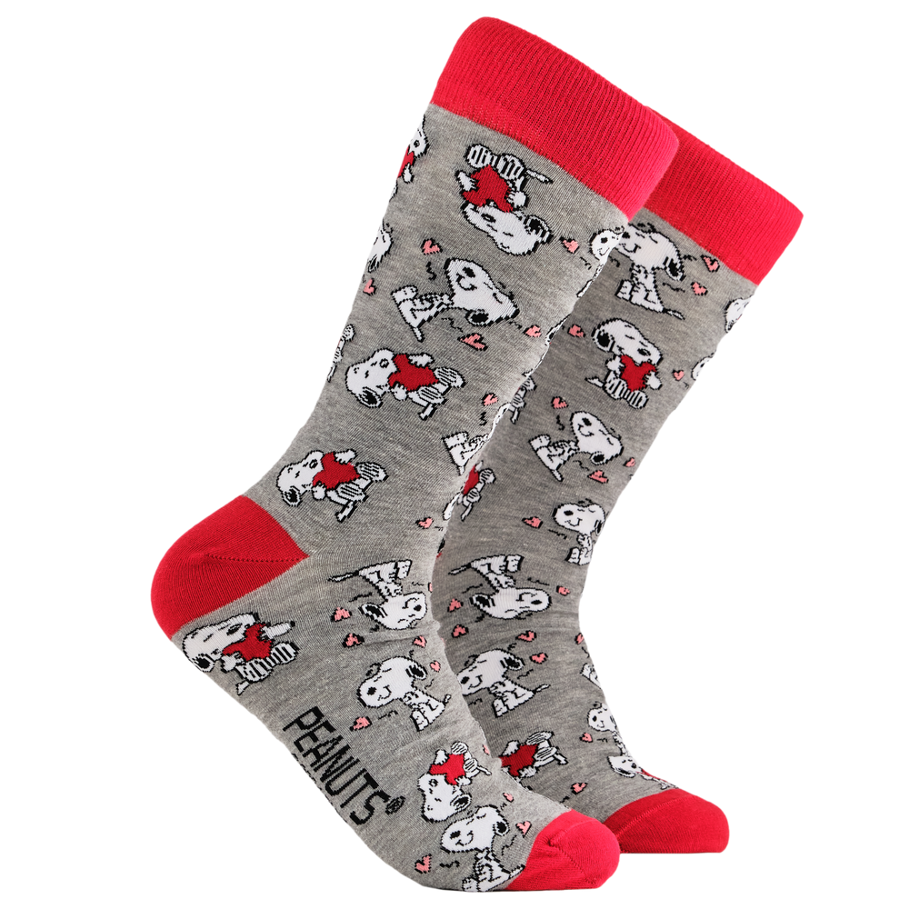 Peanuts Socks - Snoopy in Love. A pair of socks depicting Snoopy and love hearts. Grey legs, red cuff, heel and toe.