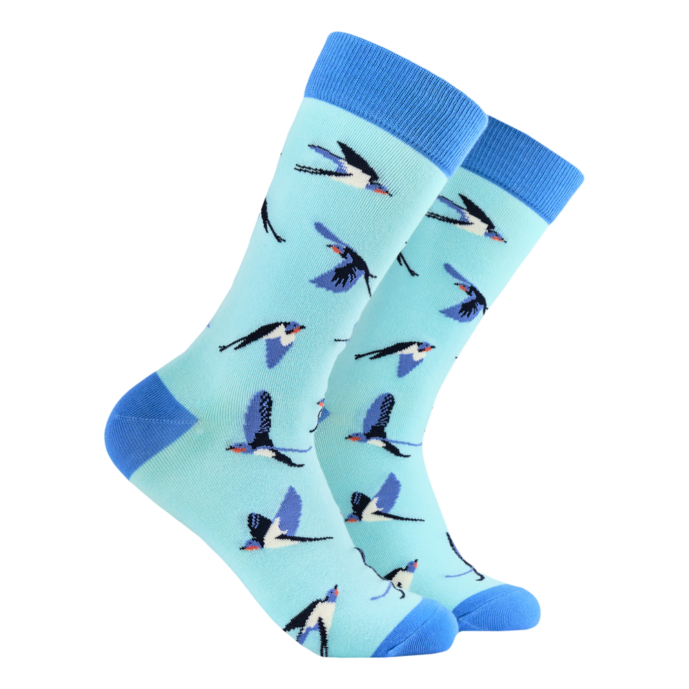 Swallows Bamboo Socks. A pair of socks featuring swallows on the wing. Light blue legs, dark blue heel, toe and cuff. 