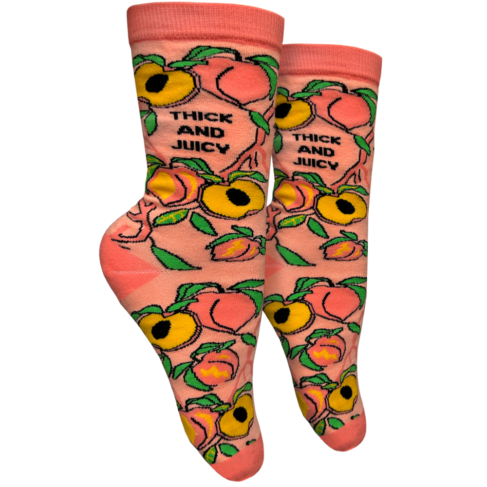 
                  
                    Thick and Juicy Socks - Small. A pair of socks with a blold slogan and bold peach design. Orange  toes, heel and cuff. 
                  
                