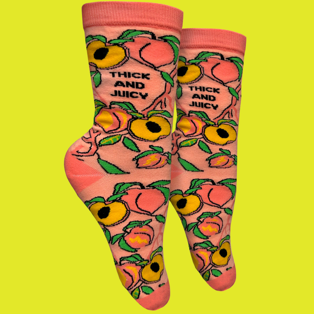 
                      
                        A pair of socks with a blold slogan and bold peach design. Orange toes, heel and cuff.
                      
                    