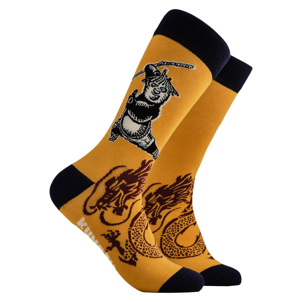 Kung Fu Panda Socks - The Dragon Warrior. A pair of socks depicting Po striking a Kung Fu pose. Yellow legs, black heel, toe and cuff.