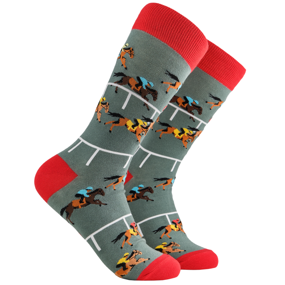 
                  
                    Horse Racing Socks - 1st Past the Post 2. A pair of socks depicting horse racing. Grey legs, red cuff and, heel and toe. 
                  
                