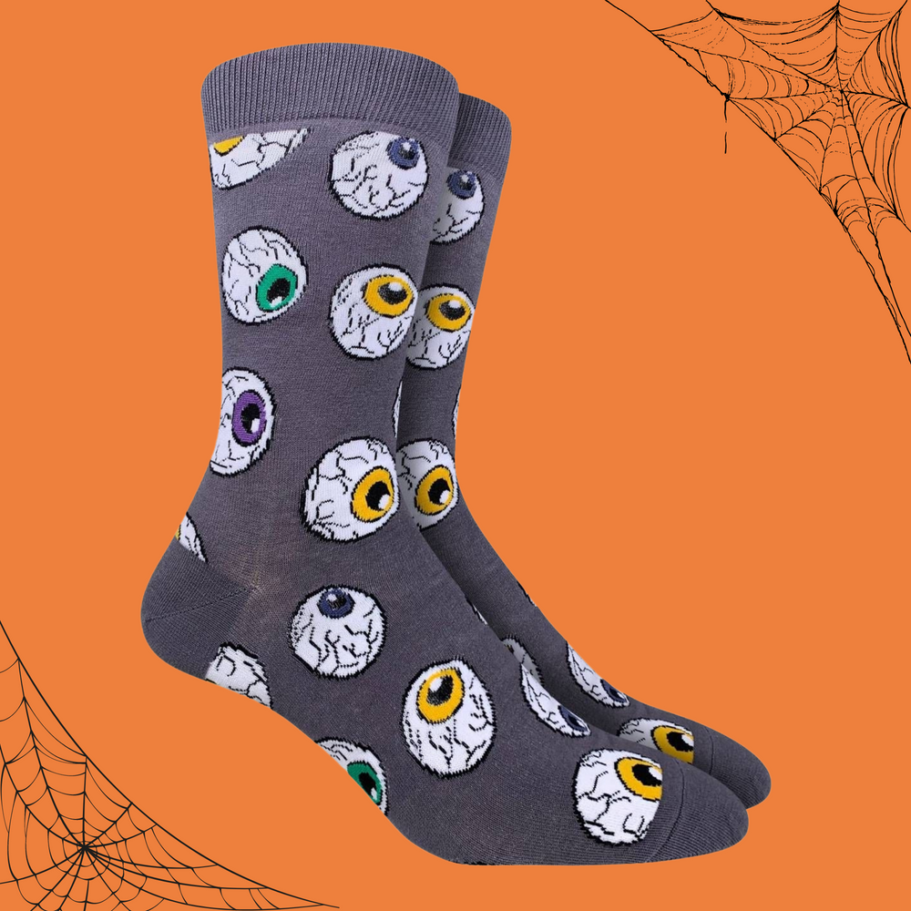 A pair of socks depicting horror style eyeballs. Grey leg, cuff, toe and heel. 