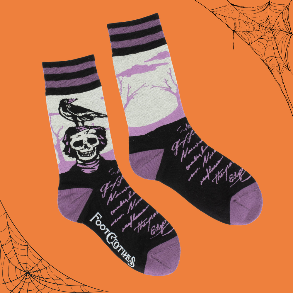 A pair of socks depicting a skeleton Edgar Allan Poe with a raven. Purple toes, heel and cuff. 