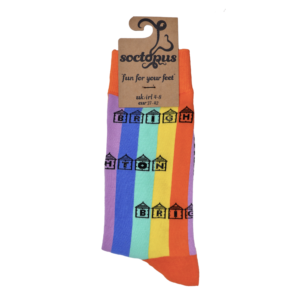 
                      
                        Rainbow striped socks with Brighton written inside beach huts. In Soctopus Packaging. 
                      
                    