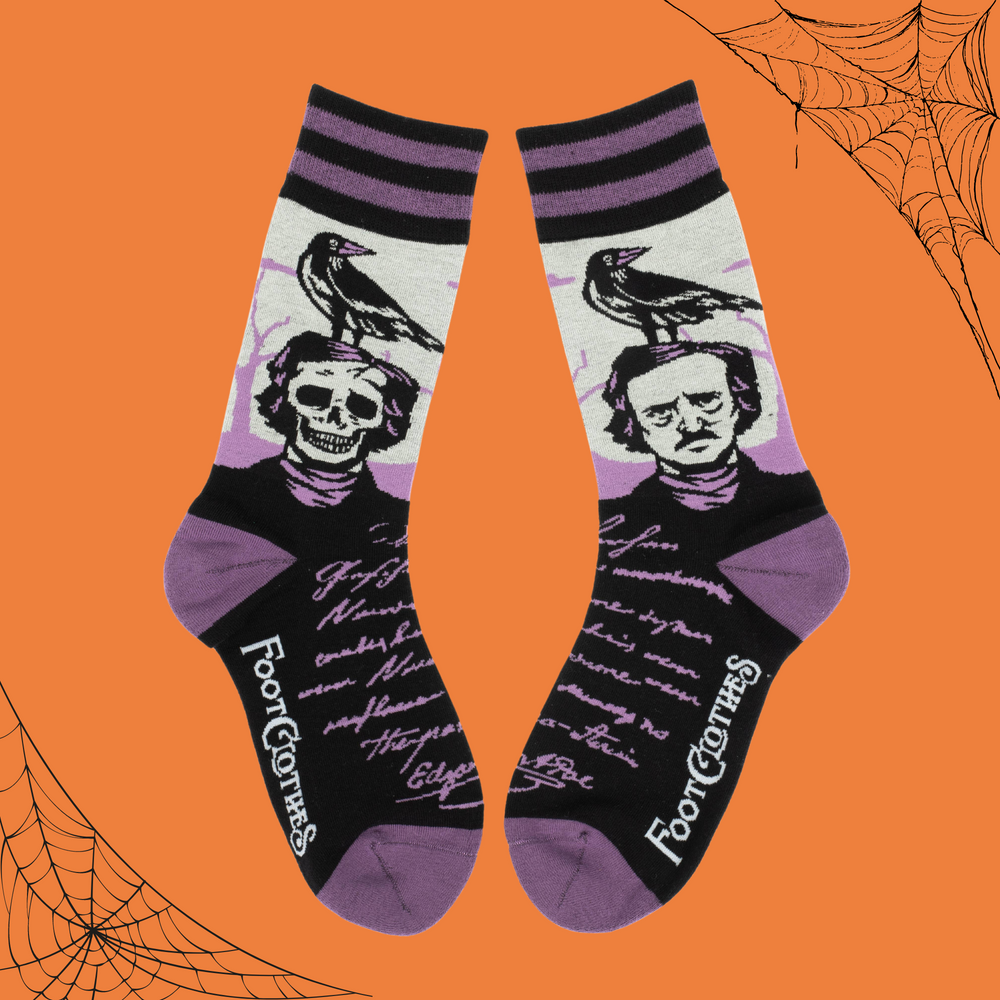 
                      
                        A pair of socks depicting a skeleton Edgar Allan Poe with a raven. Purple toes, heel and cuff. 
                      
                    