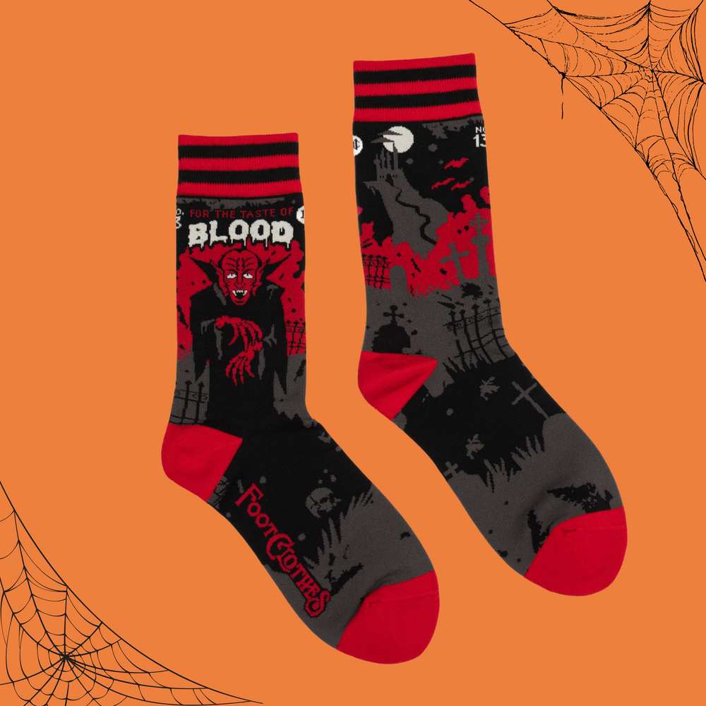 A pair of socks depicting Dracula and a vampire slogan. Red cuff, heel and toe.