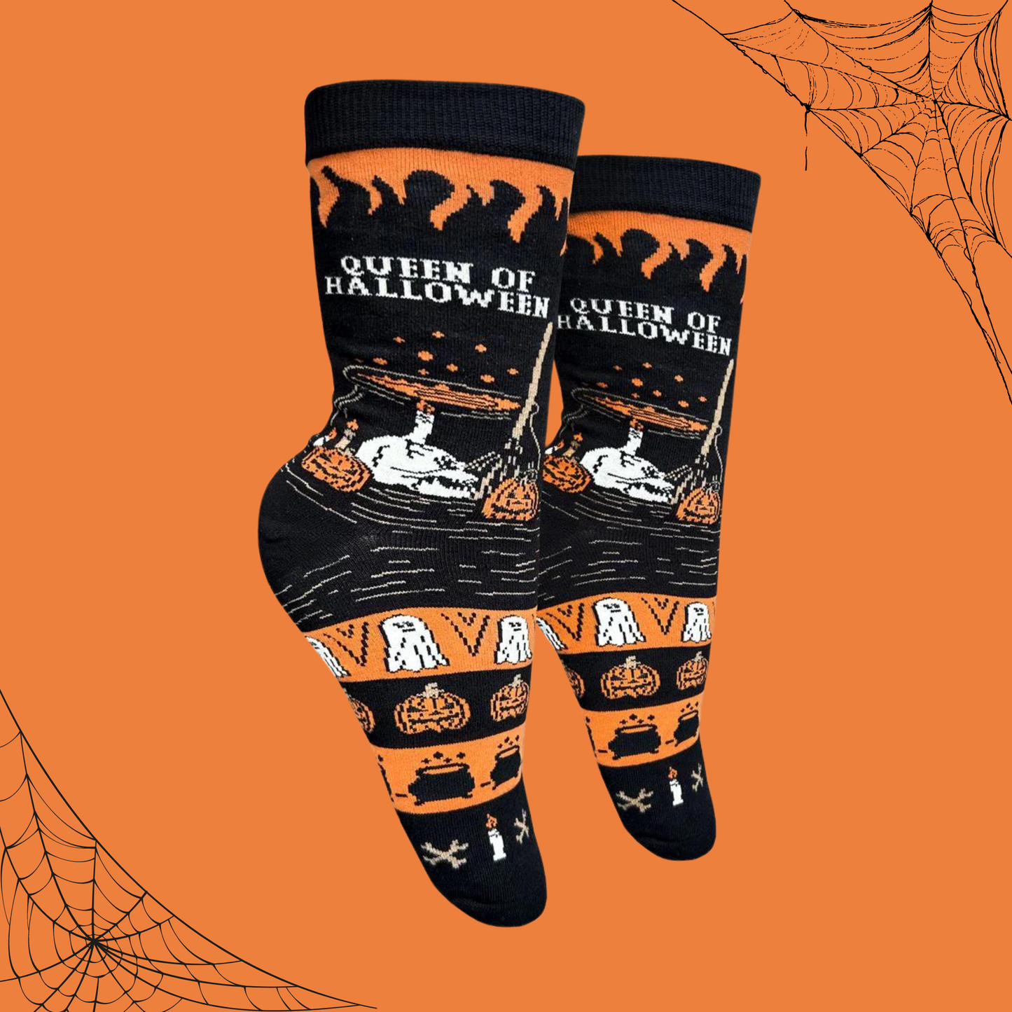 A pair of socks with an orange and black halloween motif. Ghosts, ghouls and pumpkins. 