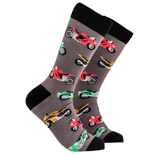 Motorbike Socks - Va Va Voom. A pair of socks depicting different coloured racing bikes. Grey legs, black cuff, heel and toe.