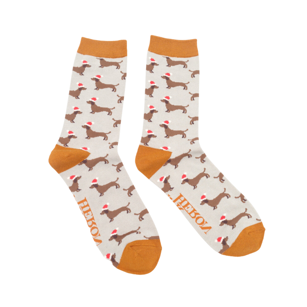 
                      
                        A pair of socks depicting sausage dogs wearing santa hats. Grey legs. Orange heel, toe and cuff. 
                      
                    