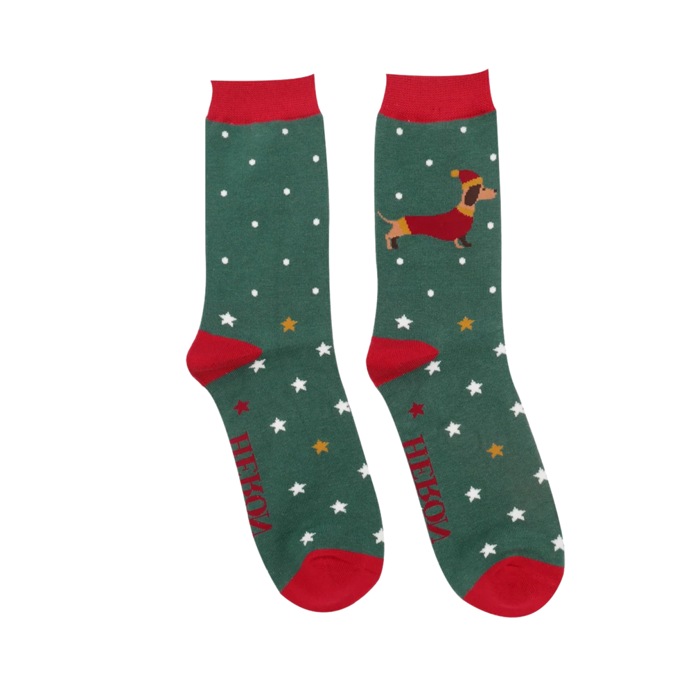 Festive Sausage Dogs Bamboo Socks - Miss Sparrow. A pair of socks depicting a festive sausage dog with a star pattern. Green legs, red toe, heel and cuff. 