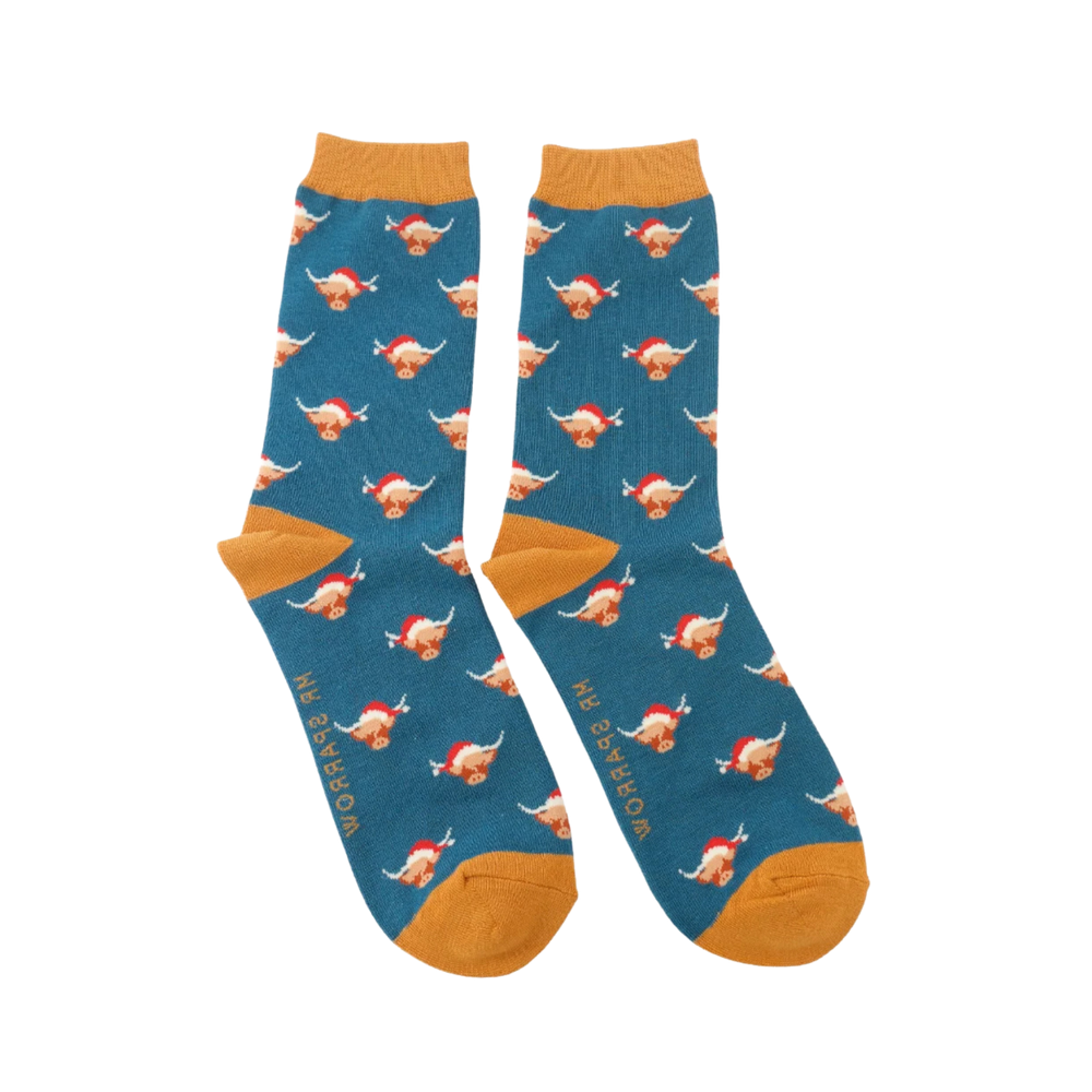 
                      
                        A pair of socks with a festive highland cow pattern. Light blue legs, orange heel, toe and cuff. 
                      
                    