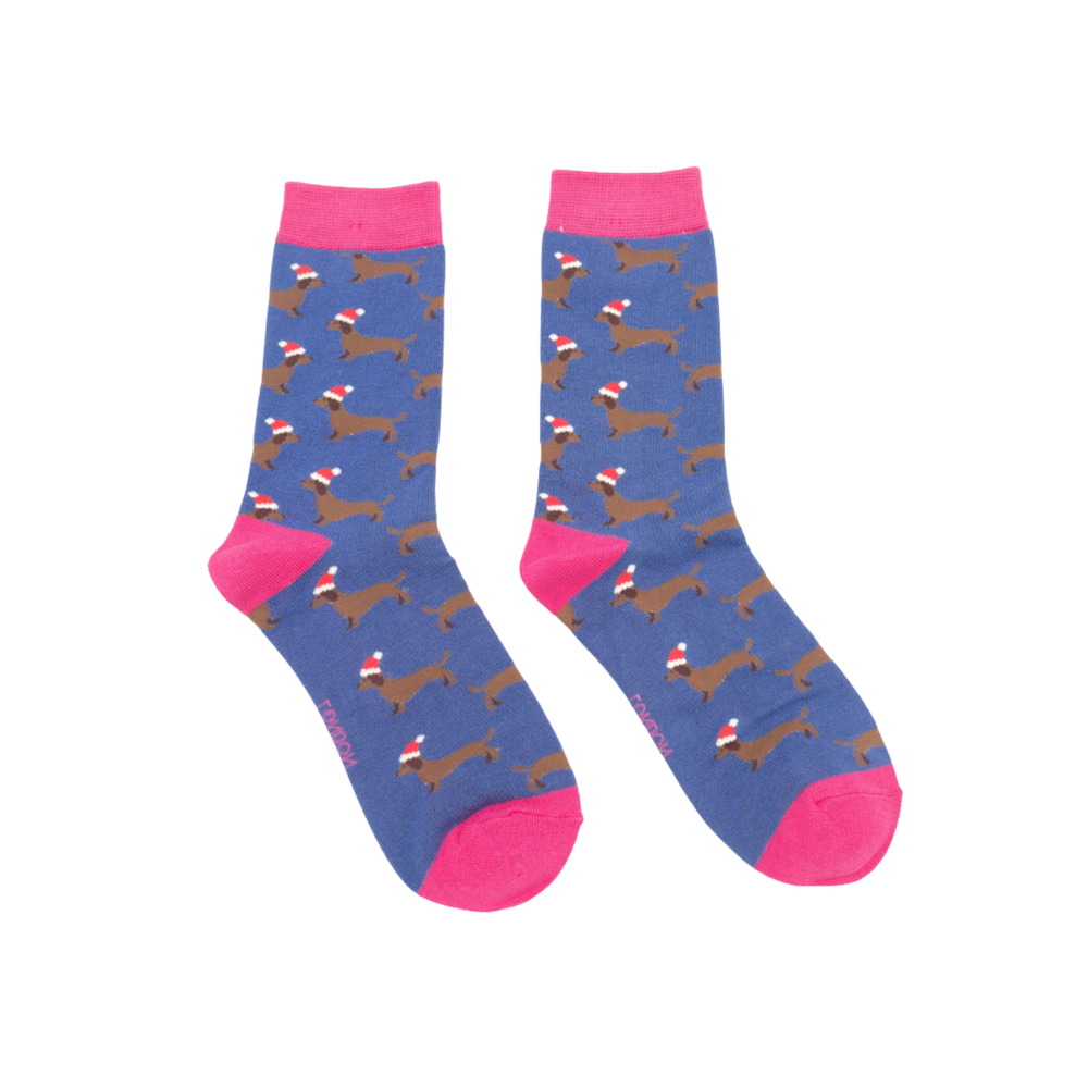 
                      
                        A pair of socks depicting sausage dogs wearing santa hats. Blue legs. Pink heel, toe and cuff. 
                      
                    